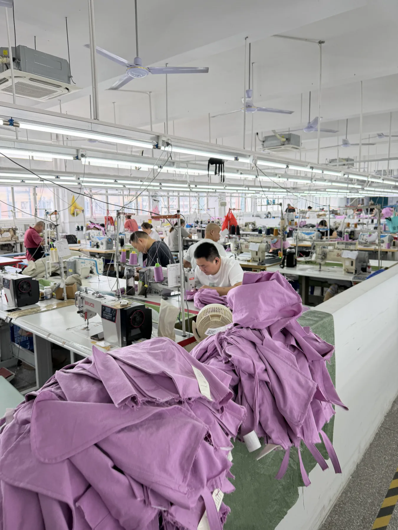 Colored garments being sewn on a production line