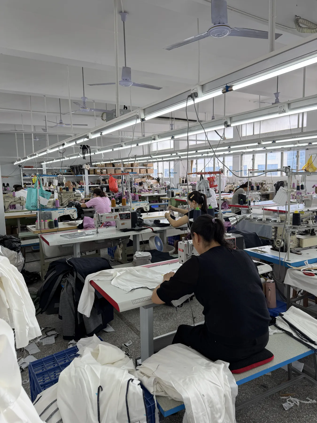 Garments moving through production inside the factory